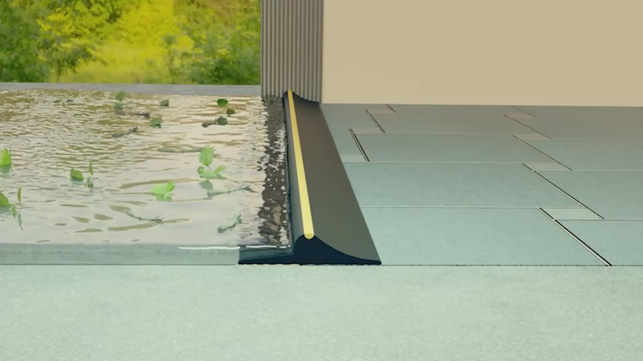 A cross section video showing a black garage door seal with a yellow accent strip, installed to block water from entering the garage.